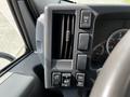 Dashboard controls of a 2016 Isuzu NQR including air conditioning vents and various switches