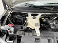 The engine compartment of a 2019 Chevrolet Express showcasing the coolant reservoir and various engine components
