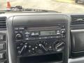 Dashboard of a 2008 Mitsubishi Fuso FE180 featuring a car stereo with knobs for volume and tuning and a digital display showing the time