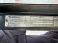 A metal identification plate displaying specifications for a 2005 Case 570 MXT Construction King tractor including model number weight and performance standards
