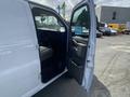 A 2022 GMC Savana van with the driver's side door open showing the interior and front seat