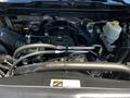 An open engine compartment of a 2015 RAM 5500 showcasing various engine components like the air intake hose and coolant reservoir