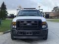A white 2008 Ford F-450 pickup truck with a black front bumper and grill facing forward