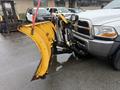 A 2011 Dodge Ram 5500 with a yellow snow plow attached to the front