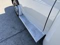 A chrome diamond plate running board on the side of a 2019 Chevrolet Express van