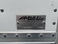 A metal nameplate attached to a Freightliner M2 106 truck indicating it is made in Canada with details about the model and serial number