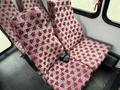 A pair of patterned seats with a red and white design in a 2015 Ford Econoline van