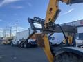 A yellow 2013 JCB 510-56 Loadall with a fork attachment is shown in the foreground, part of the lifting arm is visible