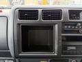 Interior view of a 2001 Toyota Dyna dashboard featuring air conditioning vents a radio compartment and a digital clock display