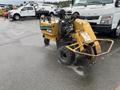 A 2014 Vermeer Corporation Sweep Stump Cutter featuring a yellow and green design with large tires and an engine compartment visible on the side