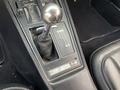 The image shows the gear shifter and console of a 1972 Chevrolet Corvette featuring a chrome ball shifter and several control levers with a vintage design