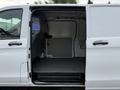 A 2020 Mercedes-Benz Metris van with the side door open revealing an empty interior space designed for cargo or equipment storage