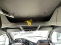 Interior view of a 2022 Freightliner Cascadia showing the overhead storage compartment with a yellow item placed inside