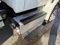 A 2017 International 4300 truck with a metallic step and access panel on the side showing components like a large air filter and exhaust system