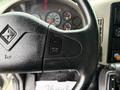 Close-up of the steering wheel of a 2012 International TerraStar featuring control buttons for cruise control and textured leather grip
