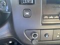 Dashboard control panel of a 2012 GMC Savana featuring buttons for various settings and an audio system with a display and multiple knobs