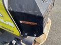 Close-up of a 2010 Kubota F3990 engine cover featuring a warning label about hot exhaust in English and Spanish