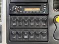 Dashboard controls of a 2011 International WorkStar featuring radio and various switches for different functions
