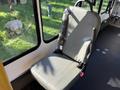 A single gray seat with a seatbelt in a vehicle interior
