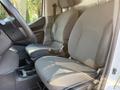 Interior of a 2021 Nissan NV200 showing two front seats and steering wheel in a commercial vehicle configuration