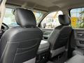The interior of a 2018 RAM 1500 showing two front seats with black leather upholstery and a view of the rear seating area
