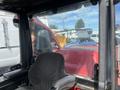 A 2014 Toro Groundmaster 5910 with a black operator seat and red exterior visible through a glass cabin enclosure