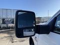 A 2023 RAM 3500 pickup truck's side mirror showing a reflective surface and a smaller inset mirror for enhanced visibility