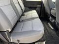 The interior of a 2024 Ford F-550 showing the back seating area with gray cloth seats and a clean, spacious layout