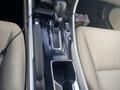 Close-up of the gear shift and center console of a 2017 Honda Accord Hybrid featuring buttons for drive modes and a sleek design in black and silver