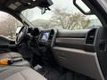 Interior of a 2021 Ford F600 featuring a modern dashboard with a touchscreen display and controls in a gray and black color scheme
