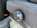 A close-up of a control knob on the seat of a 2022 TerraMac Tracked Dump showing a transparent outer casing with a black dial and numerical indicators for adjustment