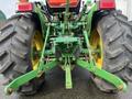 A green 2003 John Deere 790 tractor viewed from the rear showing large tires and a three-point hitch assembly