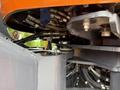 A close-up view of the hydraulic system and components of a 2018 Doosan DL300-5 with various hoses and metal parts visible