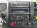 Dashboard controls of a 2018 Hino 195 featuring audio system climate control knobs and air conditioning settings