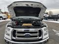 A 2017 Ford F-150 with its hood open showcases the engine compartment and various components inside