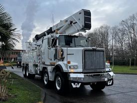 A white 2011 Western Star Trucks 4900 configured as a bucket truck with an elevated aerial lift and equipment storage compartments