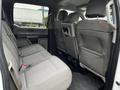 Interior view of the backseat of a 2017 Ford F-150 with gray fabric upholstery and seating for three passengers