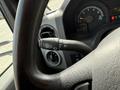A close-up view of the steering wheel of a 2010 Ford Econoline showing controls for wipers and headlights