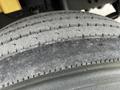 Close-up of a tire from a 2006 Hino 268 showing worn tread pattern and surface details