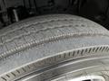 A close-up of a tire from a 2013 Hino 195 featuring visible tread patterns and a textured surface