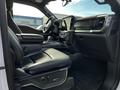 Interior of a 2021 Ford F-150 featuring black leather seats a center console and a large touchscreen display