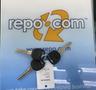 A set of keys for a 2009 Chevrolet Express with a black key fob and a tag attached listing the vehicle's details