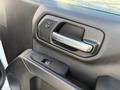 Close-up of the door handle and control buttons of a 2024 Chevrolet Silverado 1500