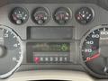 Dashboard of a 2008 Ford F-250 SD showing gauges for turbo boost, fuel level, and temperature along with a digital display for fuel economy and other metrics