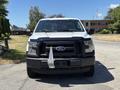 A white 2016 Ford F-150 pickup truck is shown from the front with a black grille and a unique attachment on the front bumper