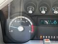 Close-up of the dashboard of a 2016 Ford F-550 showing the RPM gauge with a needle indicating low revs and a digital display of speed and distance traveled
