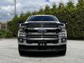 A 2020 Ford F-350 Super Duty truck with a chrome front grille and bumper, showcasing its large size and rugged design