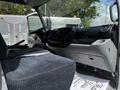 Interior view of a 2018 Hino 195 showing the driver's seat dashboard and controls with a gray color scheme and fabric upholstery