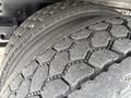 Close-up of a rugged tire from a 2017 Hino 338 featuring a hexagonal tread pattern showing wear and visible texture of the rubber surface