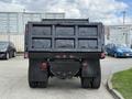 Black 2017 Ford F-750 truck viewed from the rear showing the dump bed and taillights